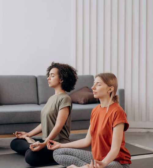 Man in a focused strength pose in a bright, minimalist room.